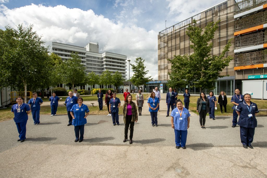 Staff from East and North Hertfordshire NHS Trust, standing in the plaza at Lister Hospital in Stevenage