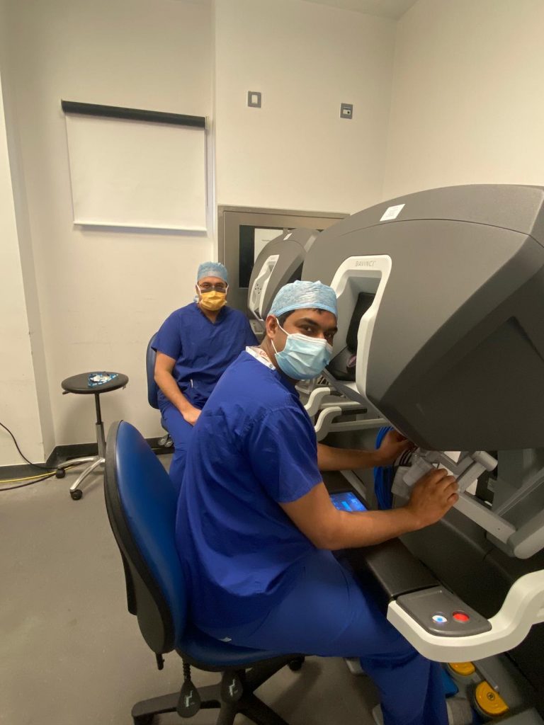 Consultant urologist Mr Nikhil Vasdev (furthest away) and Royal College of Surgeons of England fellow Arvind Nayak at the controls of the robot. 