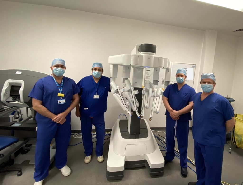 Urology consultants Mr Nikhil Vasdev, Mr Tim Lane, Mr Ben Pullar and Mr Jim Adshead, pictured next to the robot they have all been using for operations