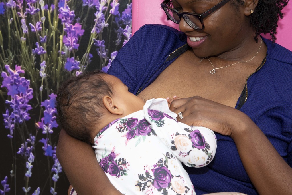 An infant being breastfed by their mother.