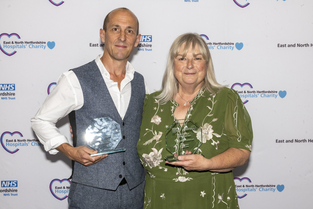 James and Jane holding their Charity Champion awards.