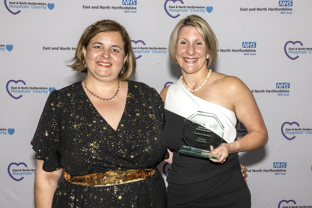 Lucy James and Lucy Davies collecting Susan Harris' Here to Help Award.