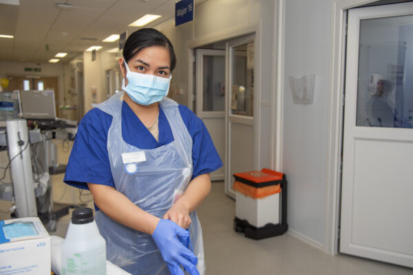 Doctor putting on gloves