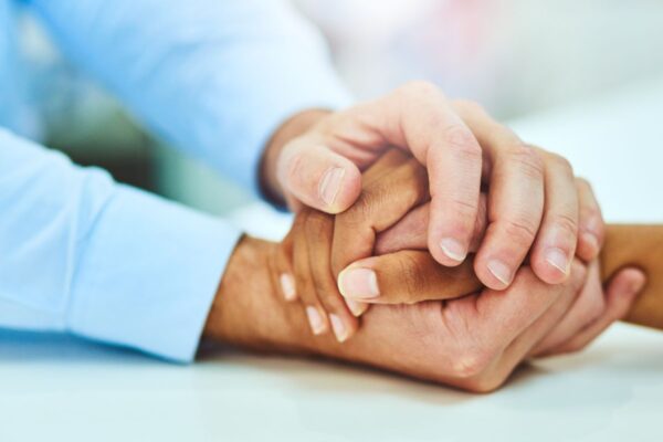 Two people holding hands