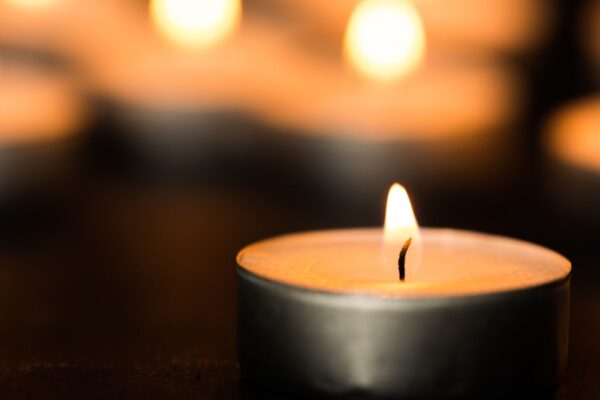 A tealight candle, with other tealight candles our of focus