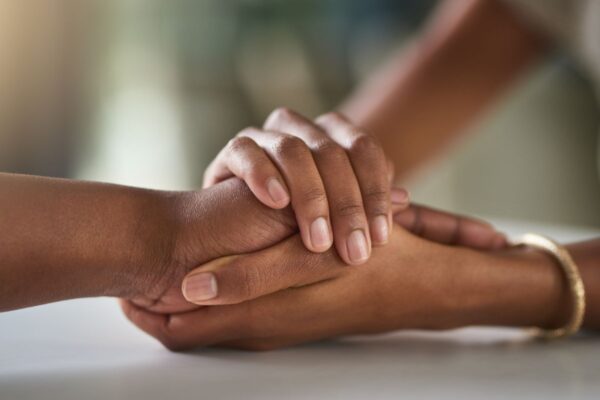 Two people holding hands