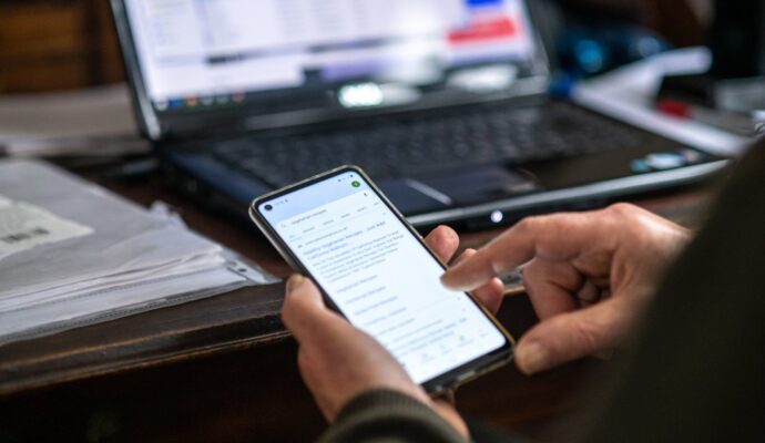 A photo of someone's hands using a smart phone.