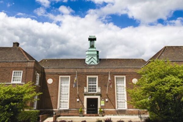 Hertfordshire County Council's coroner office, held at The Old Courthouse, Hatfield. Behind is a cloudy blue sky.