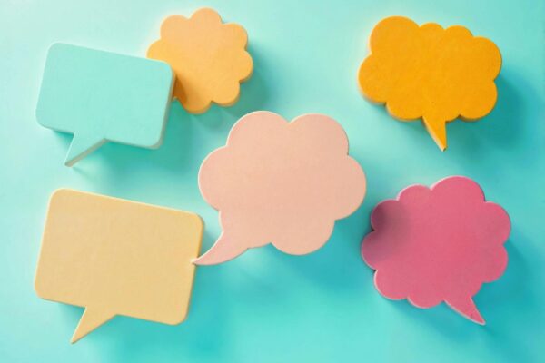 Blue background with different coloured speech and thought bubbles.