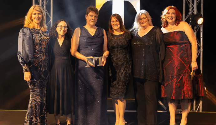 Members of staff from East and North Hertfordshire Teaching NHS Trust stood on stage with their award.