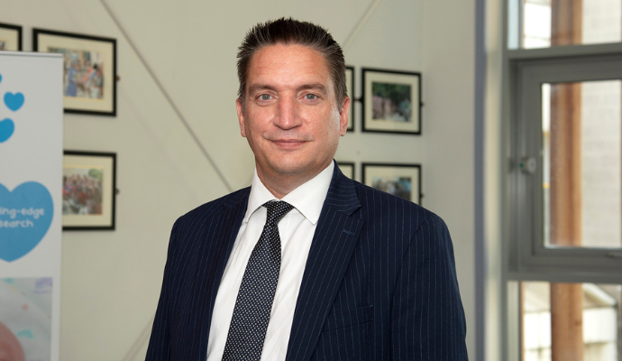 A headshot image of Adam Sewell-Jones, taken at the Lister Diamond Jubilee Maternity Unit.