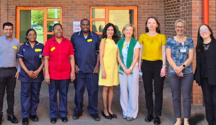 Members of staff located at Mount Vernon Cancer Centre posing for a photograph.