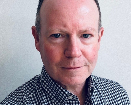 A professional headshot photo of Barry Jenkins, interim Chief Finance Officer at East and North Hertfordshire Teaching NHS Trust.