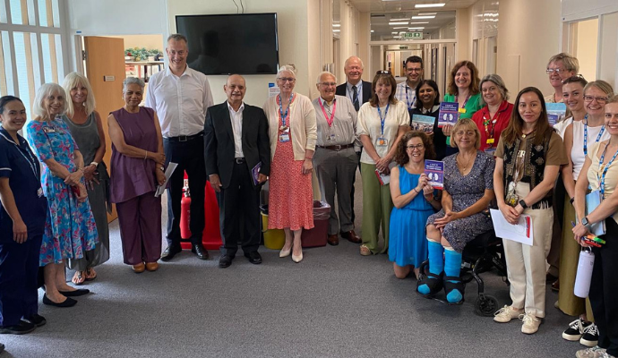 A group of patients and LAKPA representatives gathered for a photograph along the Trust Management corridor at Lister Hospital in Stevenage.