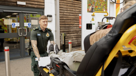 An ambulance crew member offloading a patient from the ambulance into the Ambulance Handover Unit at Lister Hospital.