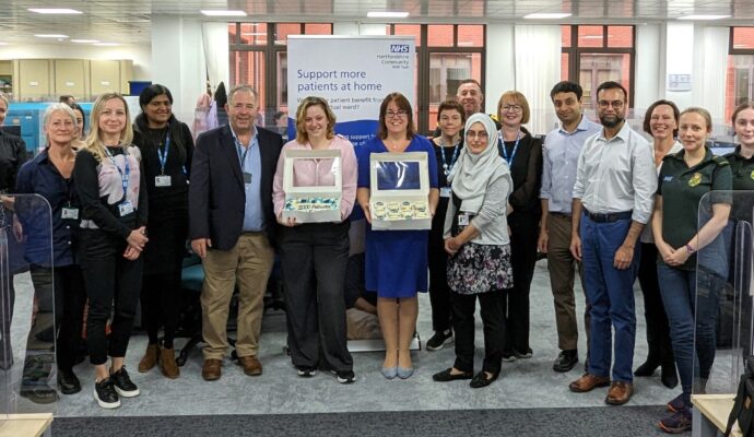 An image taken during a celebration event where members of the Hospital at Home team were celebrating the milestone of 1,000 patients who have been cared for on a virtual ward.